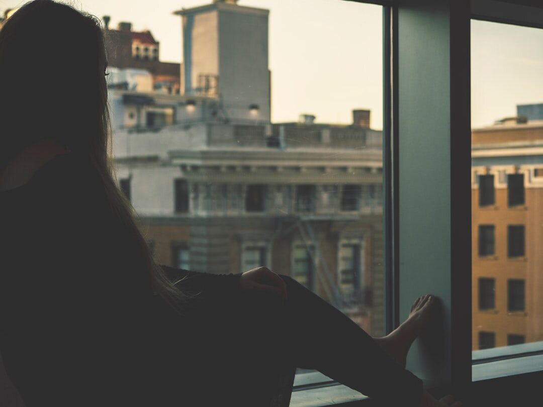 person reflecting by window
