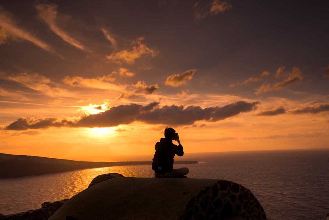 person meditating at sunrise